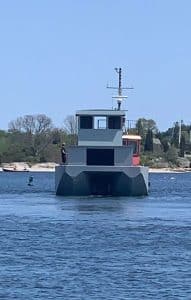 Fitzgerald Metalworks. A grey workboat or utility vessel on the water.