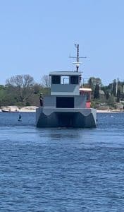 Fitzgerald Metalworks. A grey workboat or utility vessel on the water.