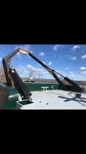 Fitzgerald Metal Works. boat during construction with a prominent A-frame structure.