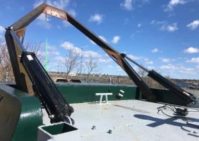 Fitzgerald Metal Works. boat during construction with a prominent A-frame structure.