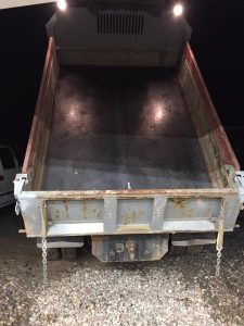 Fitzgerald Metalworks. The rear view of a dump truck with its bed raised