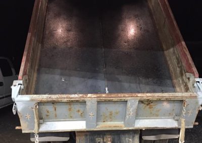 Fitzgerald Metalworks. The rear view of a dump truck with its bed raised