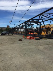 Fitzgerald Metalworks. A construction site with a large crane boom structure laid out on the ground.