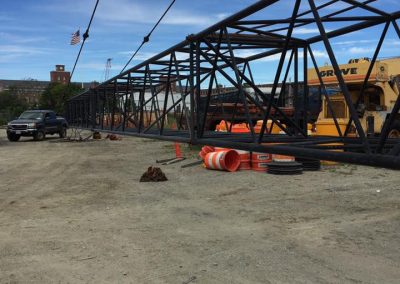 Fitzgerald Metalworks. A construction site with a large crane boom structure laid out on the ground.