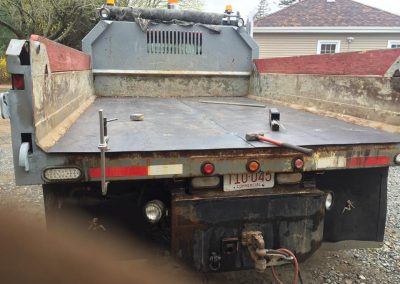 Fitzgerald Metalworks. The rear view of a flatbed truck with a raised dump bed