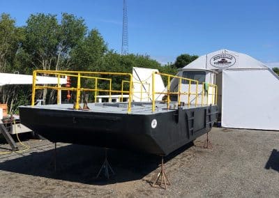 Fitzgerald Metal Works. Black barge hull with yellow iron railings