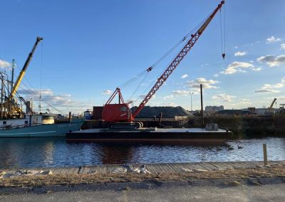 Fitzgerald Metalworks. Red and black Crane Barge on water.