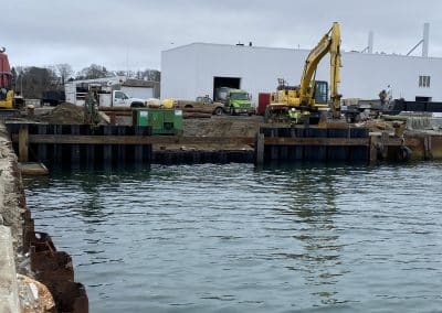 Fitzgerald Metalworks. Marine Construction Site on water's edge. Yellow excavator in background