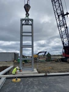 Fitzgerald Metalworks. An active construction site with a large metal frame structure being lifted by a crane.