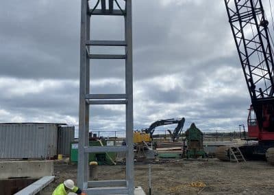 Fitzgerald Metalworks. An active construction site with a large metal frame structure being lifted by a crane.