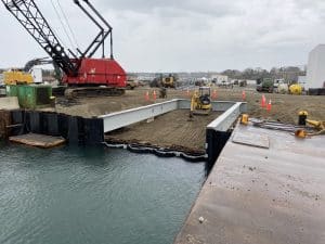 Fitzgerald Metal Works. Marine Construction with iron beams leading to calm body of water.