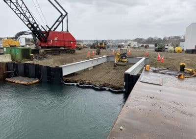 Fitzgerald Metal Works. Marine Construction with iron beams leading to calm body of water.