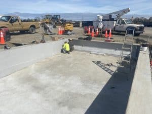 Fitzgerald Metalworks. Two marine construction workers working on the interior of a barge on an outdoor construction site.