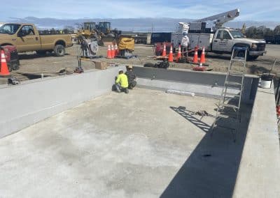 Fitzgerald Metalworks. Two marine construction workers working on the interior of a barge on an outdoor construction site.