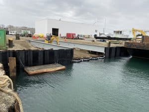 Fitzgerald Metal Works. Marine Construction with iron beams leading to calm body of water.