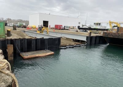 Fitzgerald Metal Works. Marine Construction with iron beams leading to calm body of water.