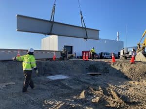 Fitzgerald Metal Works. large steel beam being lifted by a crane.