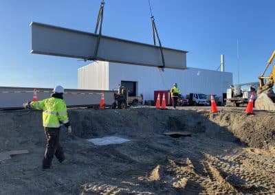 Fitzgerald Metal Works. large steel beam being lifted by a crane.