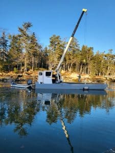 Fitzgerald Metalworks. White crane barge in water.