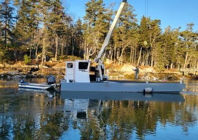 Fitzgerald Metalworks. White crane barge in water.