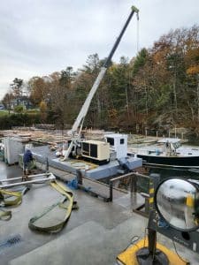 Fitzgerald Metalworks. Crane barge attached to boat in water.