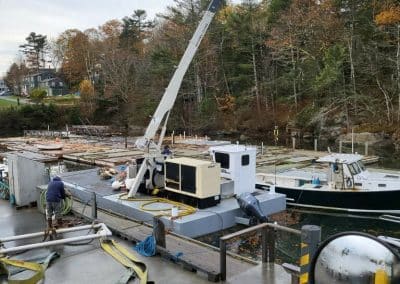 Fitzgerald Metalworks. Crane barge attached to boat in water.