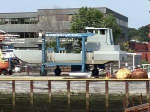 Fitzgerald Metalworks. A large grey catamaran-style barge vessel being transported on a boat lift