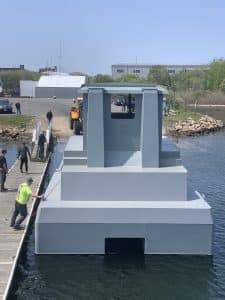 Fitzgerald Metalworks. A large catamaran-style vessel being launched into the water for the first time.