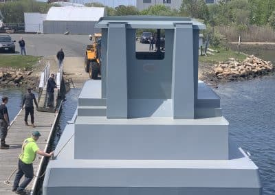 Fitzgerald Metalworks. A large catamaran-style vessel being launched into the water for the first time.