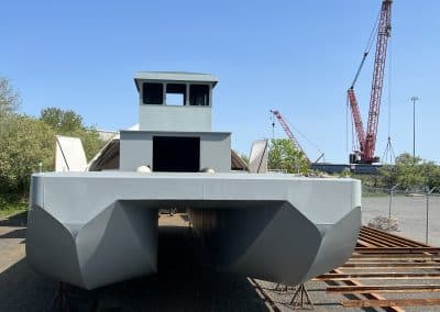 Fitzgerald Metalworks. A large catamaran-style barge vessel under construction