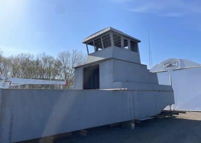 Fitzgerald Metalworks. A large vessel, that is a catamaran style barge, under construction or in the early stages of assembly.