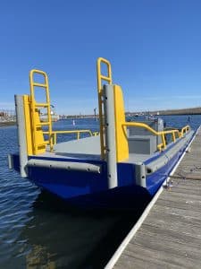 Fitzgerald Metalworks. A barge docked at a pier, ready for use on the water.