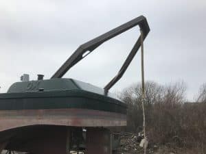 Fitzgerald Metal Works. Stern of a green and brown boat