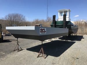 Fitzgerald Metal Works. Two boats in an outdoor marine industrial area