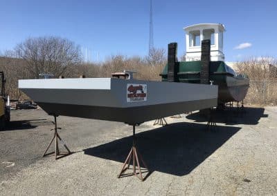 Fitzgerald Metal Works. Two boats in an outdoor marine industrial area