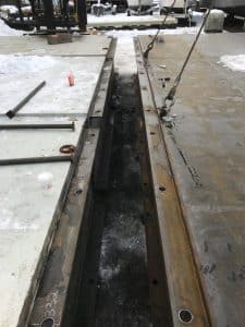 Fitzgerald Metal Works. marine construction site during winter in between two large parallel metal beams