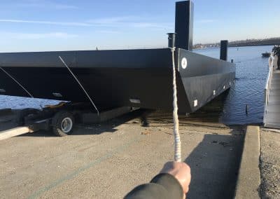 Fitzgerald Metal Works. Large black barge being launched into the water