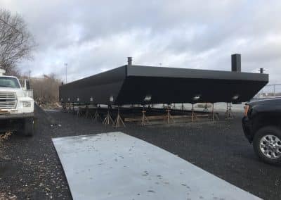 Fitzgerald Metal Works. Newly constructed black barge on stands