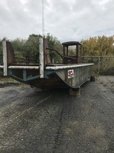 Fitzgerald Metal Works. Old, rusted metal barge boat hull sitting on supports