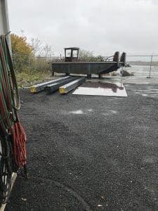 Fitzgerald Metal Works. barge metal boat hull on supports in boat yard