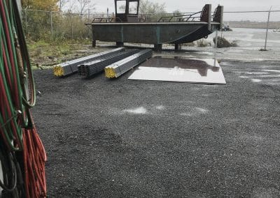 Fitzgerald Metal Works. barge metal boat hull on supports in boat yard