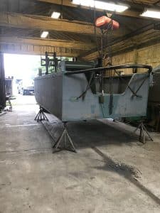 Fitzgerald Metal Works. Back view of Metal boat hull in process of being constructed in workshop