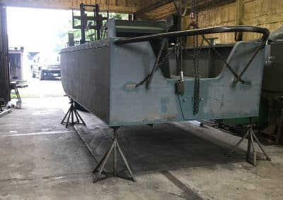 Fitzgerald Metal Works. Back view of Metal boat hull in process of being constructed in workshop