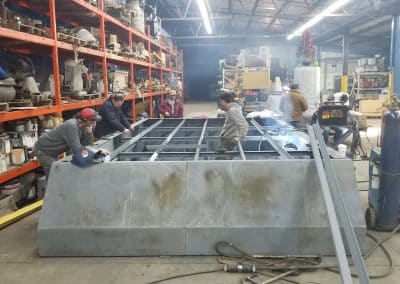 Fitzgerald Metal Works. Marine fabrication professionals working on constructing a barge boat