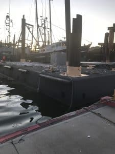 Fitzgerald Metal Works. dock at marina at sunset or sunrise with fishing boats