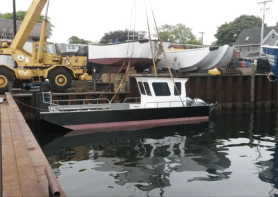 Fitzgerald Metal Works. Yellow crane launching a boat into the water